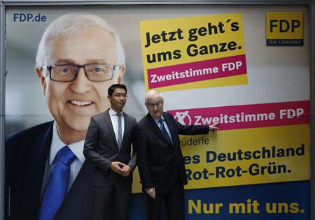 German Economy minister Philipp Roesler (L) chairman of the liberal Free Democratic Party (FDP) and the FDP's top candidate Rainer Bruederle stand in front of an election campaign poster following a FDP board meeting in Berlin, September 16, 2013. REUTERS/Fabrizio Bensch