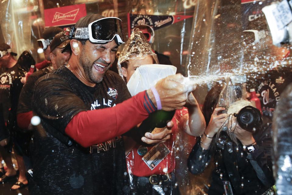Washington Nationals manager Dave Martinez celebrates after Game 4 of the baseball National League Championship Series against the St. Louis Cardinals Wednesday, Oct. 16, 2019, in Washington. The Nationals won 7-4 to win the series 4-0. (AP Photo/Patrick Semansky)