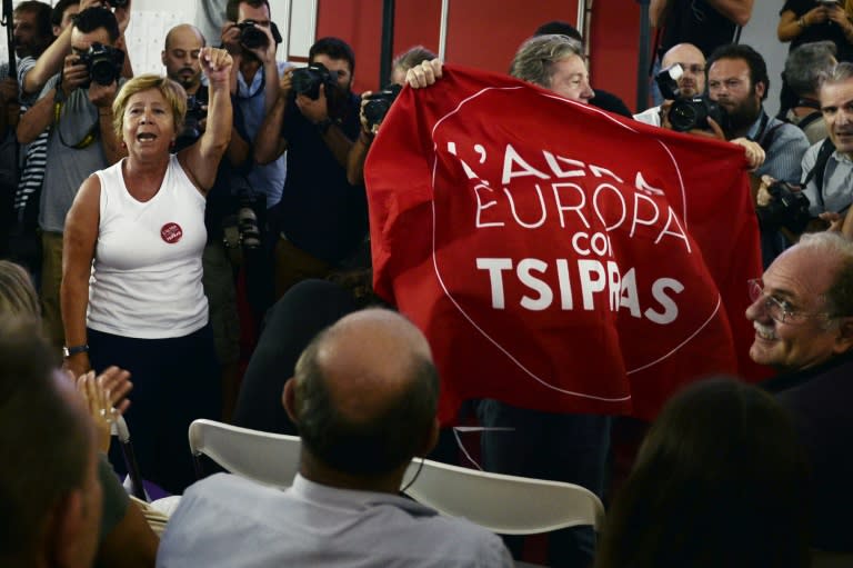 Syriza supporters react at the announcement of the first exit polls in Athens on September 20, 2015