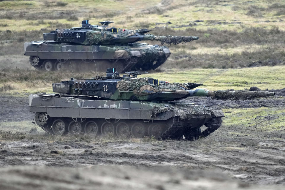 FILE - Two Leopard 2 tanks are seen in action during a visit of German Defense Minister Boris Pistorius at the Bundeswehr tank battalion 203 at the Field Marshal Rommel Barracks in Augustdorf, Germany, Feb. 1, 2023. Russia claimed it had "annihilated" eight tanks that NATO countries provided to Ukraine. But a visual analysis by The Associated Press shows a grainy black-and-white video Russia released prove it had blown up the German-made Leopard tanks actually documented the destruction of a tractor. (AP Photo/Martin Meissner, File)