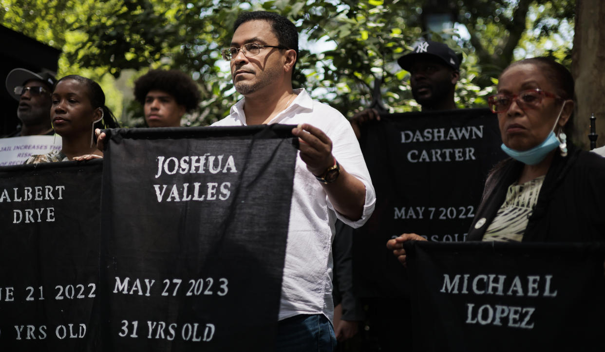 Protesters hold up banners with the names of persons who have died in the last two years while incarcerated at Rikers Island. They include one saying: Joshua Valles, May 27, 2023, 31 Years Old, as well as others for Albert Drye, Dashawn Carter and Michael Lopez. 