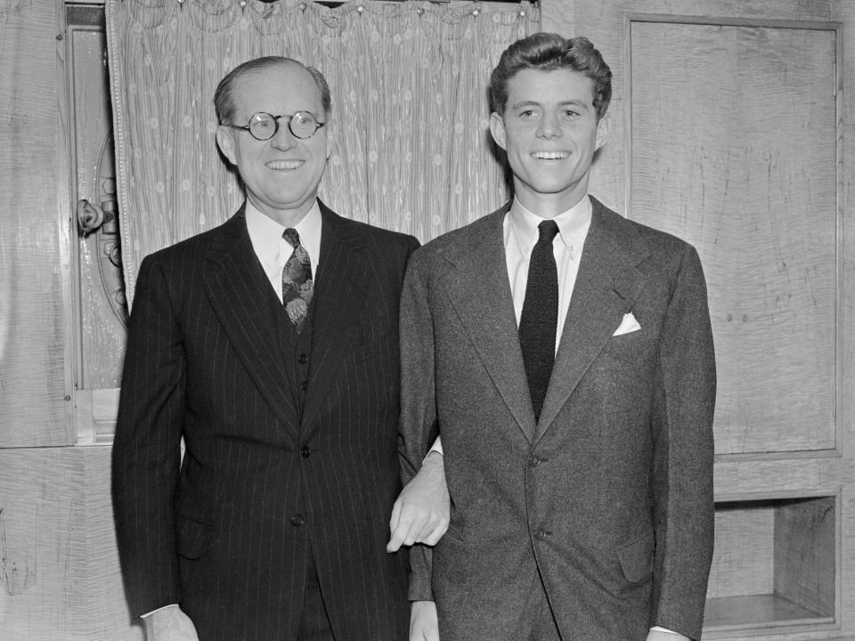 John F. Kennedy and his father Joe P. Kennedy poses for photographers onboard the SS Queen Mary in 1938.