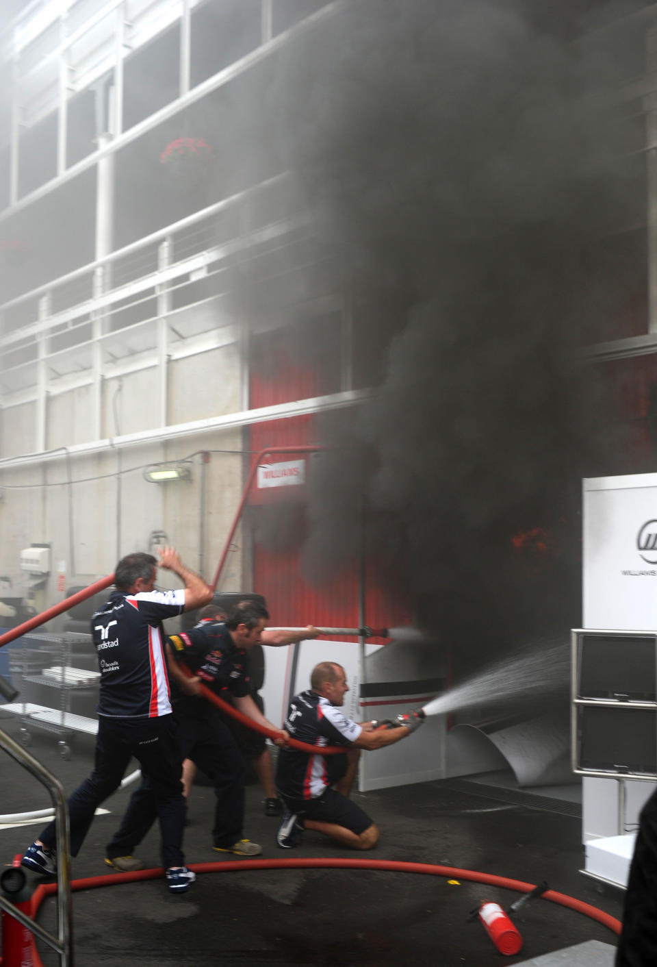 Racing team crews try to extinguish a fire in the Williams racing pit stand at the Circuit de Catalunya on May , 2012 in Montmelo on the outskirts of Barcelona after the Spanish Formula One Grand Prix. AFP PHOTO / DIMITAR DILKOFFDIMITAR DILKOFF/AFP/GettyImages