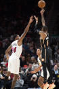 Atlanta Hawks guard Dejounte Murray shoots a three pointer against Miami Heat forward Haywood Highsmith during the second half of an NBA basketball game, Sunday, Nov. 27, 2022, in Atlanta. (AP Photo/Hakim Wright Sr.)