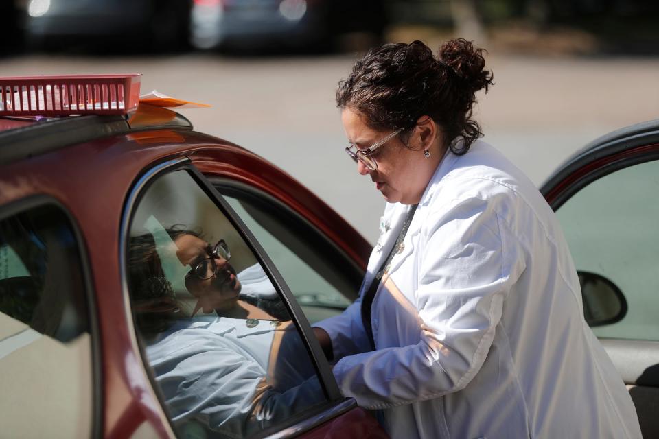 Nurse Practitioner Samantha Soto prepares to give a flu vaccination during a drive through clinic at the St. Joseph's/Candler Good Samaritan Clinic in Garden City.