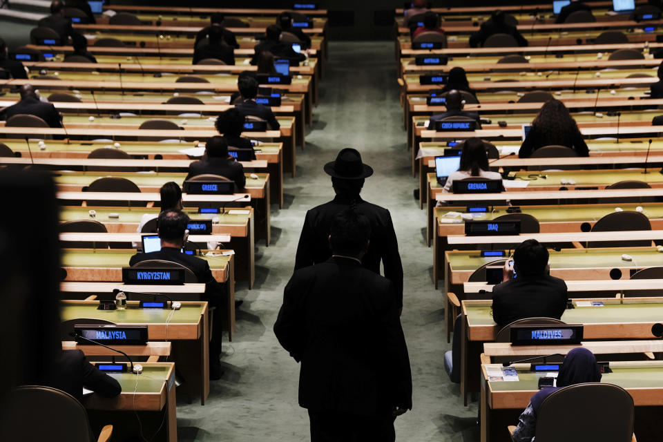 Delegates walk into the annual gathering for the 76th session of the United Nations General Assembly (UNGA) Tuesday, Sept. 21, 2021. (Spencer Platt/Pool Photo via AP)