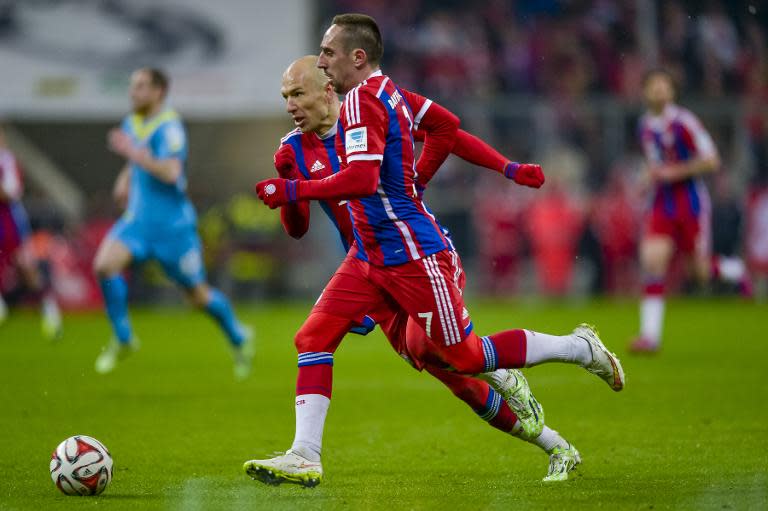 Bayern Munich's midfielders Arjen Robben and Franck Ribery play the ball during the Bundesliga football match FC Bayern Muenchen vs 1 FC Koeln in Munich on February 27, 2015