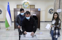 A man casts his ballot at a polling station during the presidential election in Tashkent, Uzbekistan, Sunday, Oct. 24, 2021. Uzbeks voted Sunday in a presidential election that the incumbent is expected to win in a landslide against weak competition. Although Shavkat Mirziyoyev has relaxed many of the policies of his dictatorial predecessor, he has made little effort at political reform. He took office in 2016 upon the death of Islam Karimov and faces four relatively low-visibility candidates who did not even show up for televised debates. (AP Photo)