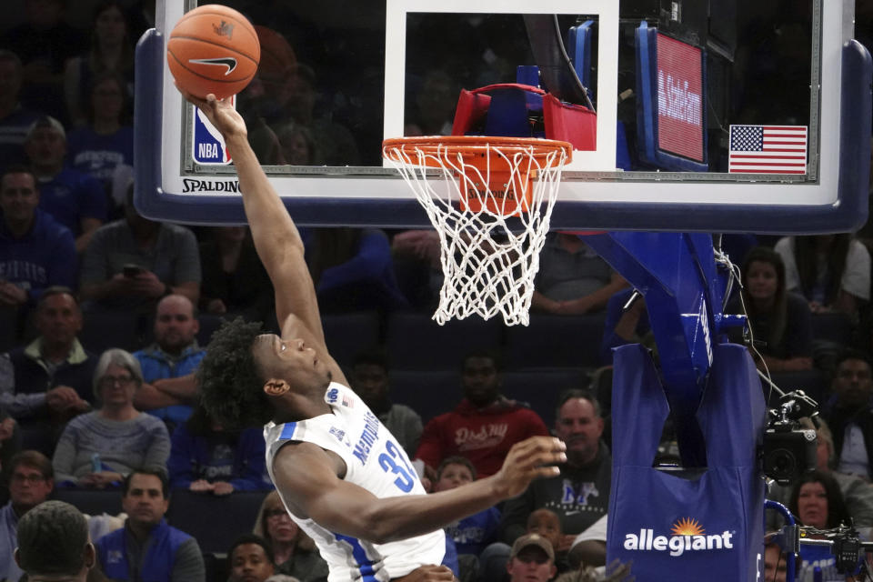 FILE - In this Tuesday, Nov. 5, 2019, file photo, Memphis' James Wiseman (32) dunks against South Carolina State during the first half of an NCAA college basketball game in Memphis, Tenn. Wiseman says he has withdrawn from school as the likely NBA lottery pick gets ready to begin his pro caree (AP Photo/Karen Pulfer Focht, File)