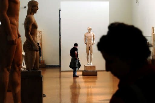 A visitor looks at antiquities at the National Archeological Museum in Athens on March 18, 2012. Faced with massive public debt, Greece is finding that its fabled antiquity heritage is proving a growing burden. "Greece's historic remains have become our curse," whispers an archaeologist worried about budgets that are badly stretched to nonexistent
