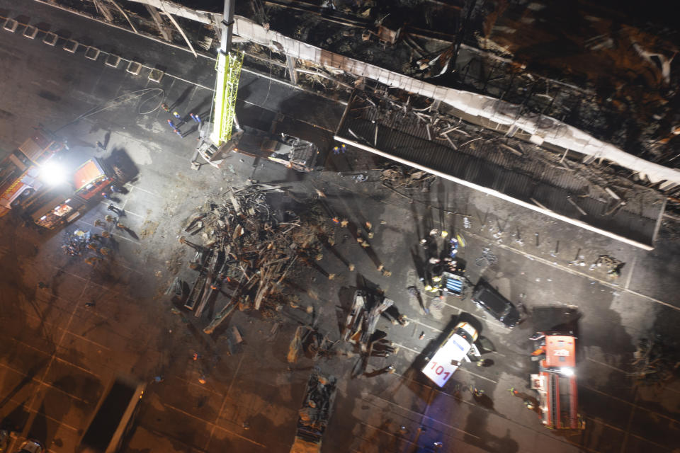 Ukrainian State Emergency Service firefighters work to extinguish a fire at a shopping center burned after a rocket attack in Kremenchuk, Ukraine, late Monday, June 27, 2022. (AP Photo/Efrem Lukatsky)