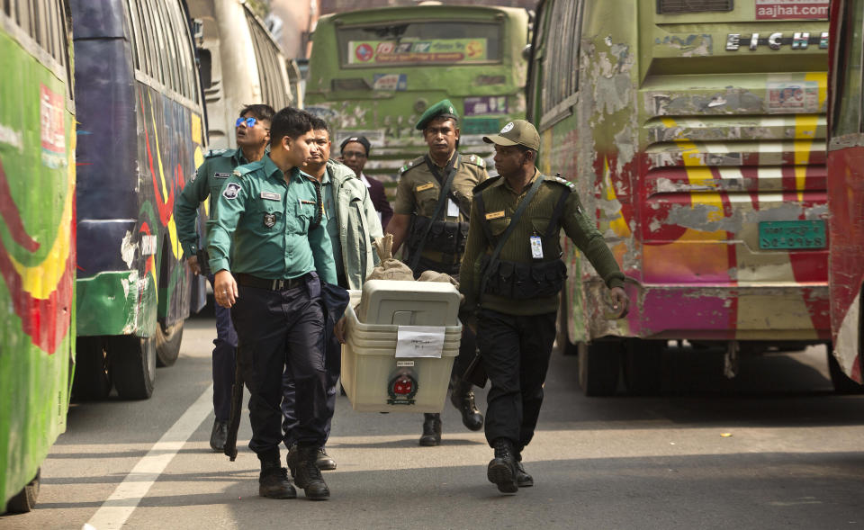 Bangladeshi security personnel carry voting material before being transported to different polling stations on the eve of the general elections in Dhaka, Bangladesh, Saturday, Dec. 29, 2018. Bangladesh Prime Minister Sheikh Hasina is poised to win a record fourth term in Sunday's elections, drumming up support by promising a development bonanza as her critics question if the South Asian nation's tremendous economic success has come at the expense of its already fragile democracy. (AP Photo/Anupam Nath)