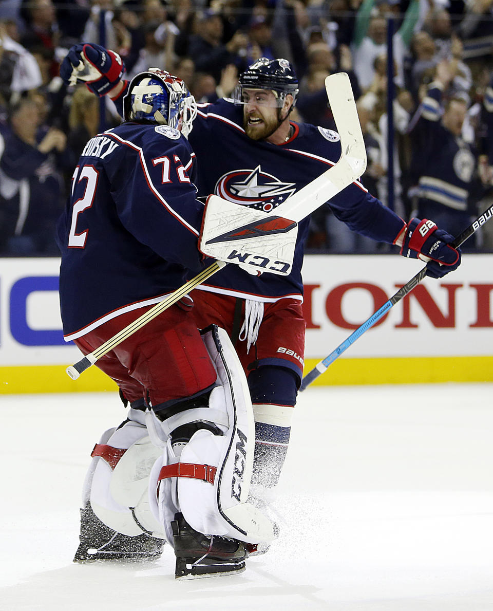 Columbus Blue Jackets' Sergei Bobrovsky, left, of Russia, and Brandon Dubinsky celebrate their win over the Tampa Bay Lightning in Game 4 of an NHL hockey first-round playoff series, Tuesday, April 16, 2019, in Columbus, Ohio. The Blue Jackets beat the Lightning 7-3. (AP Photo/Jay LaPrete)