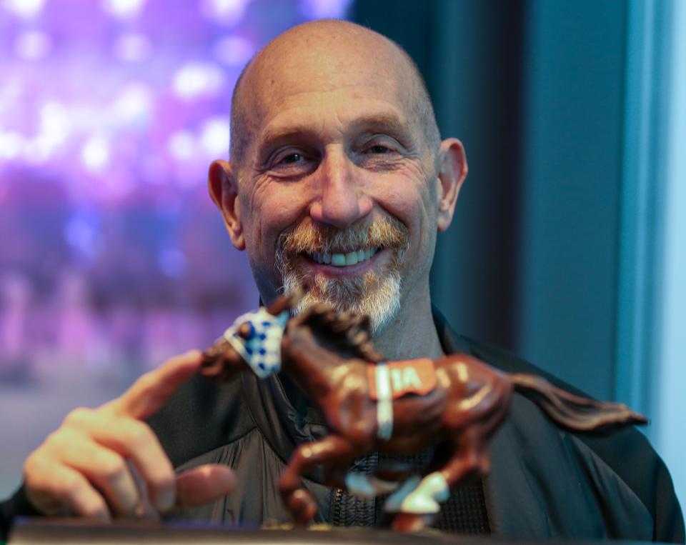 Leonard Lusky at the Kentucky Derby Museum on Thursday, April 6, 2023.  He helped to develop and bring to market the Secretariat bobblehead the he is posing with.