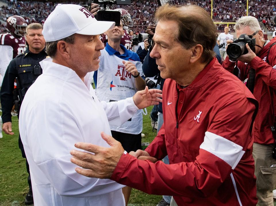 Texas A&M head coach Jimbo Fisher, left, and Alabama head coach Nick Saban meet at midfield after their game in College Station, Texas, in 2019.