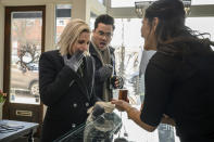 This image released by Hulu shows Kristen Stewart, left, and Dan Levy in a scene from "Happiest Season." (Jojo Whilden/Hulu via AP)