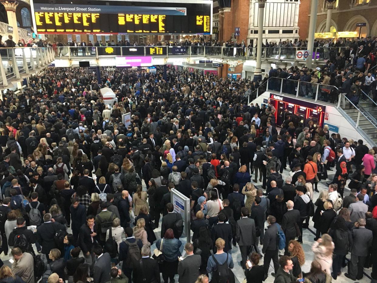 Commuters waited in the lobby of Liverpool Street station in central London: @eljonarexhaj
