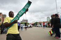 <p>A man reacts with a sign reading “Robert Mugabe Road” during a demonstration marching towards the State House while demanding the resignation of Zimbabwe’s president on Nov. 18, 2017 in Harare. (Photo: AFP/Getty Images) </p>