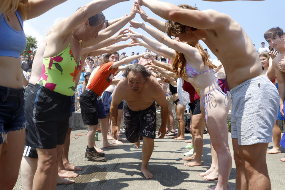 Dan O'Conor, the "Great Lake Jumper," makes his way through a tunnel for his 365th leap into Lake Michigan, Saturday, June 12, 2021, in Chicago's Montrose Point. (AP Photo/Shafkat Anowar)