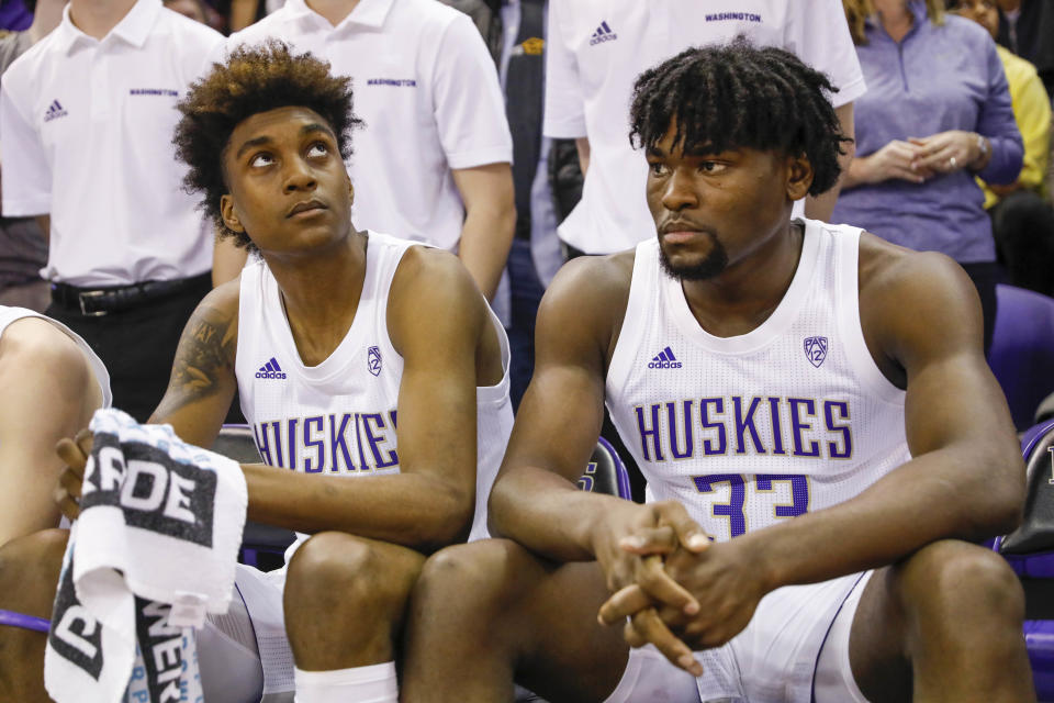 Washington Huskies forwards Jaden McDaniels (0) and Isaiah Stewart (33) sit on the bench before player introductions against Washington State. (USA Today)