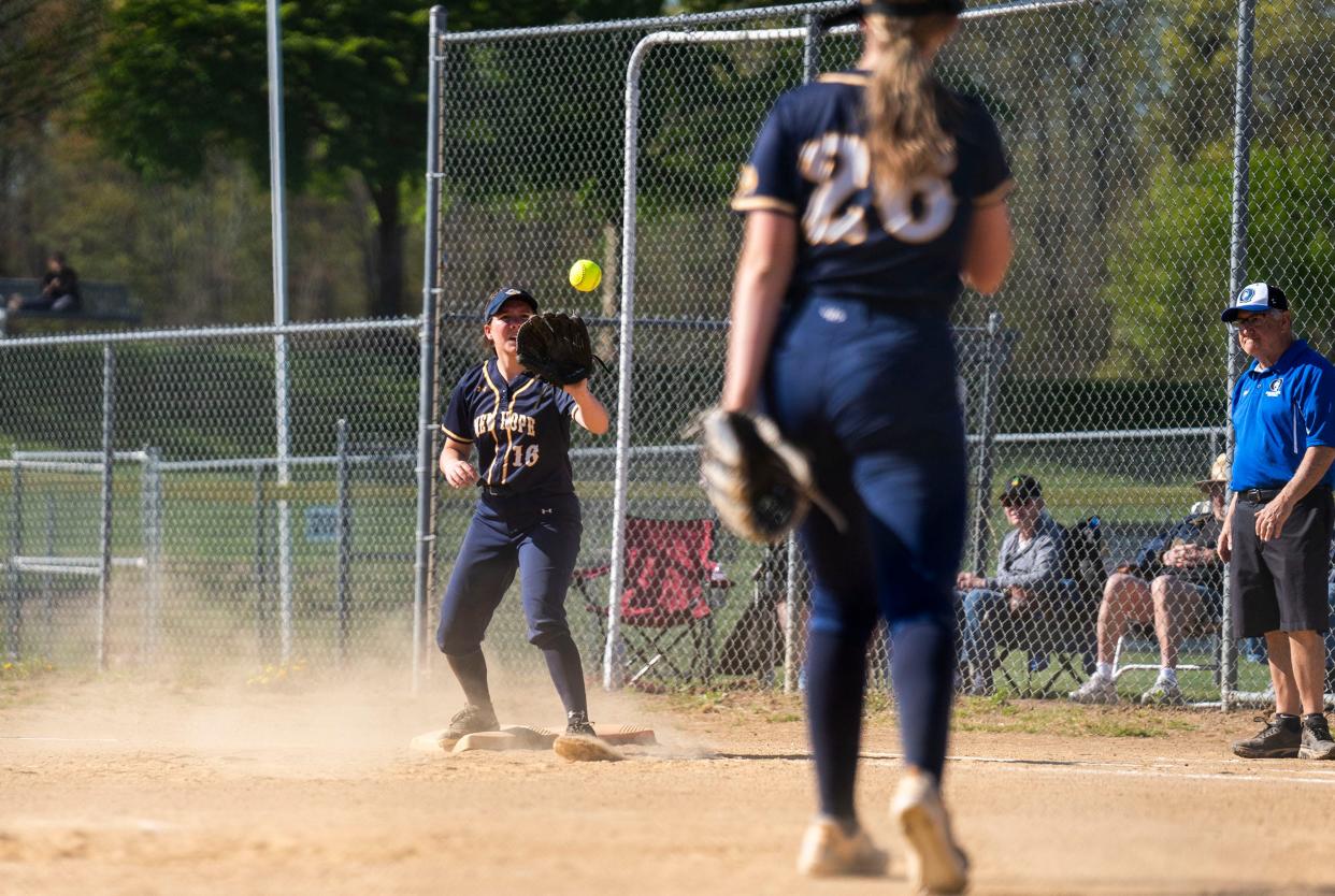 New Hope-Solebury's Dagny Mobley (26) throws to Emily Wilson (16) at first base to tag out a Quakertown batter during their softball game at the Richland Area Softball Association in Quakertown on Friday, April 26, 2024.