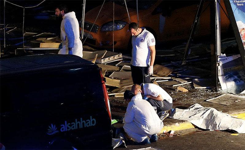 Forensic officers work near the area where three terrorists detonated explosive vests after opening fire with Kalashnikovs. Photo: Reuters