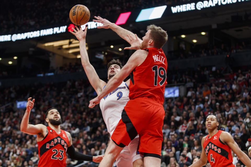 Washington Wizards forward Deni Avdija (9) is defended at the net by Toronto Raptors center Jakob Poeltl (19) during the first half of an NBA basketball game in Toronto, Sunday, March 26, 2023. (Cole Burston/The Canadian Press via AP)