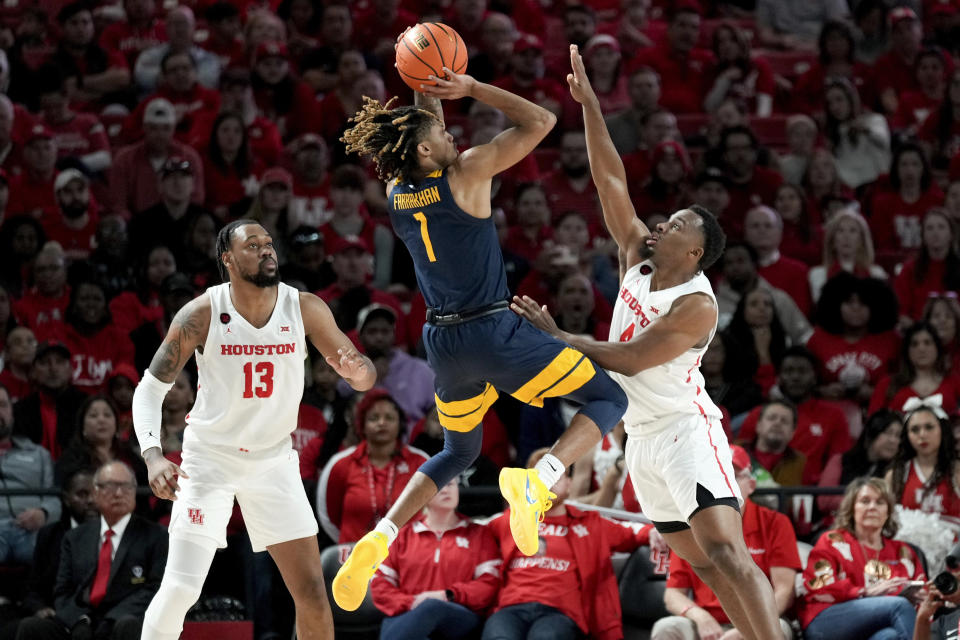 West Virginia guard Noah Farrakhan (1) shoots as Houston guard L.J. Cryer, right, defends during the first half of an NCAA college basketball game Saturday Jan. 6, 2024, in Houston. (AP Photo/Eric Christian Smith)