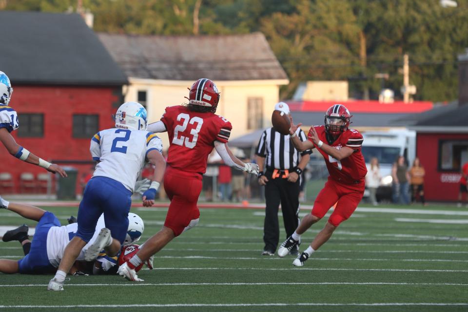 Coshocton's Colton Conkle grabs a lateral against Maysville. Conkle returns for his second season under center in the Coshocton Wing-T offense.