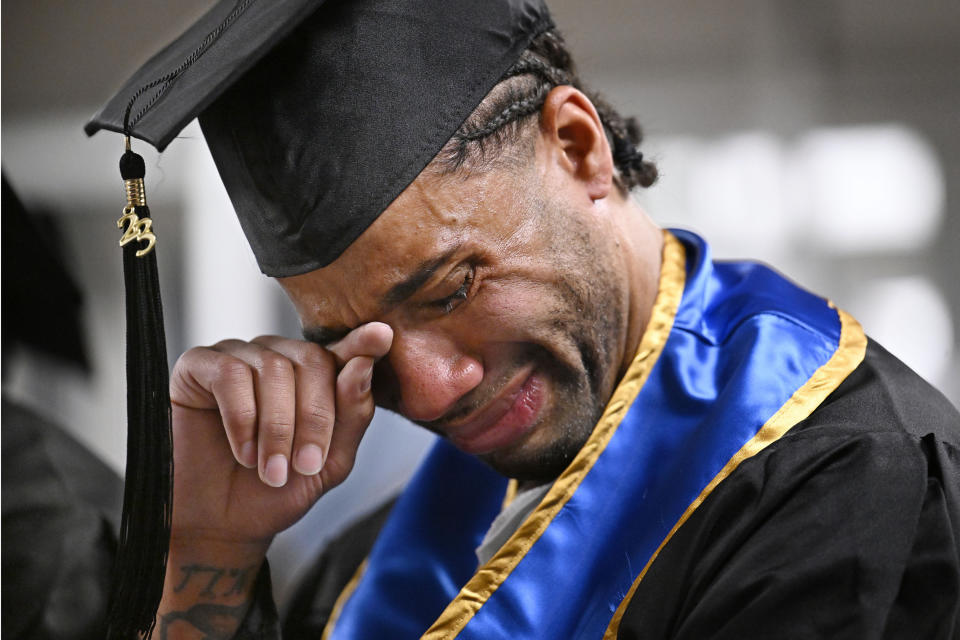 Future graduate Evan Holmes wipes tears from his eyes after delivering a speech at the first-ever college graduation ceremony at MacDougall-Walker Correctional Institution in June. 