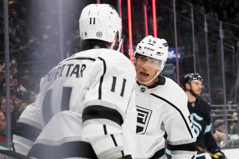 Los Angeles Kings right wing Quinton Byfield (55) celebrates with center Anze Kopitar (11) after Kopitar's goal against the Seattle Kraken during the second period of an NHL hockey game Saturday, Dec. 16, 2023, in Seattle. (AP Photo/Lindsey Wasson)