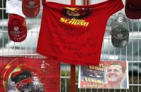 Caps, flags and a shirt marking the 45th birthday of seven-times former Formula One world champion Michael Schumacher are placed outside his cart racing track, in the western city of Kerpen, Germany, January 3, 2014. REUTERS/Ina Fassbender