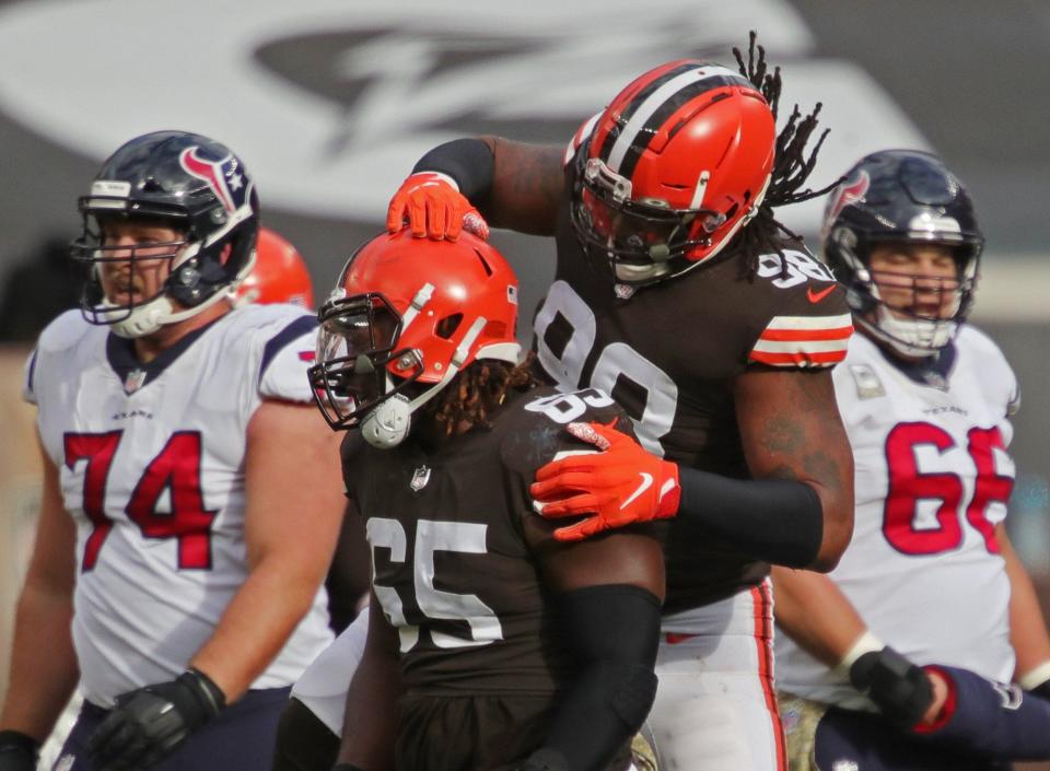 Browns defensive tackle Larry Ogunjobi (65) is congratulated by Browns defensive tackle Sheldon Richardson (98) after sacking Houston Texans quarterback Deshaun Watson (4) during the first half of an NFL football game, Sunday, Nov. 15, 2020, in Cleveland, Ohio. [Jeff Lange/Beacon Journal]