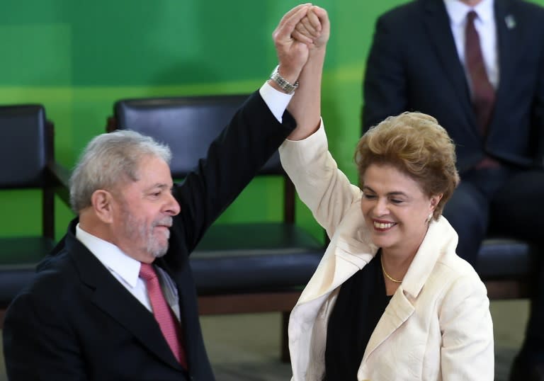 Former Brazilian president Luiz Inacio Lula da Silva (L) and Brazilian president Dilma Rousseff gesture during Lula's swear in ceremony as chief of staff, in Brasilia on March 17, 2016