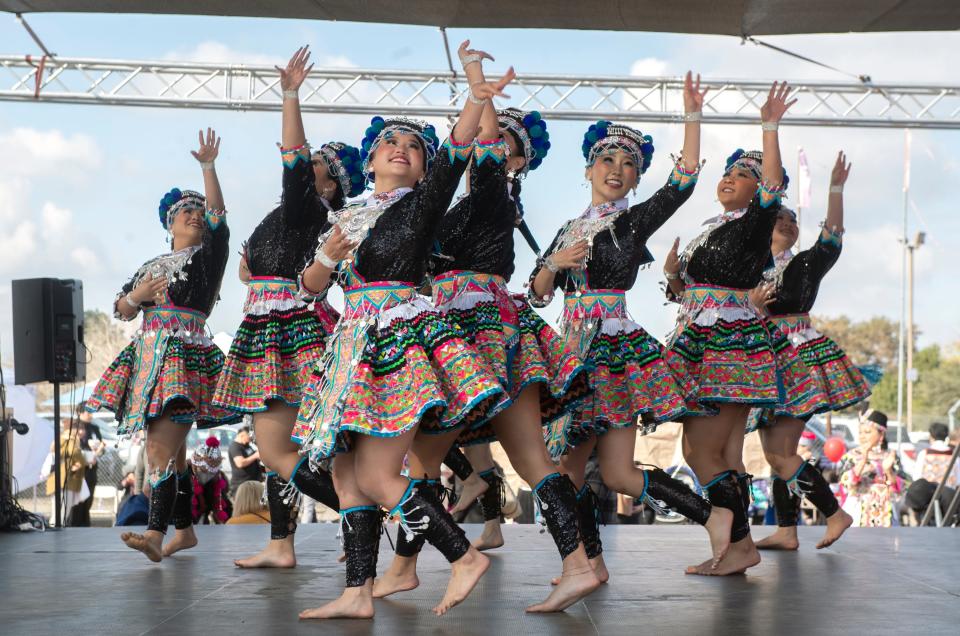 The Nkauj Haum Keej dance group performs in the dance competition at the Stockton Hmong New Year Festival at the 99 Speedway in Stockton on Saturday, Nov. 12, 2022. 