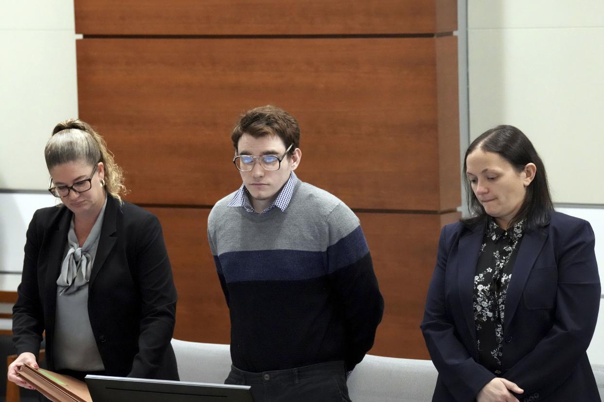 Marjory Stoneman Douglas High School shooter Nikolas Cruz, center, stands with members of his defense team as the jury enters the courtroom during the penalty phase of his trial at the Broward County Courthouse in Fort Lauderdale, Fla., on Monday, Sept. 12, 2022. 