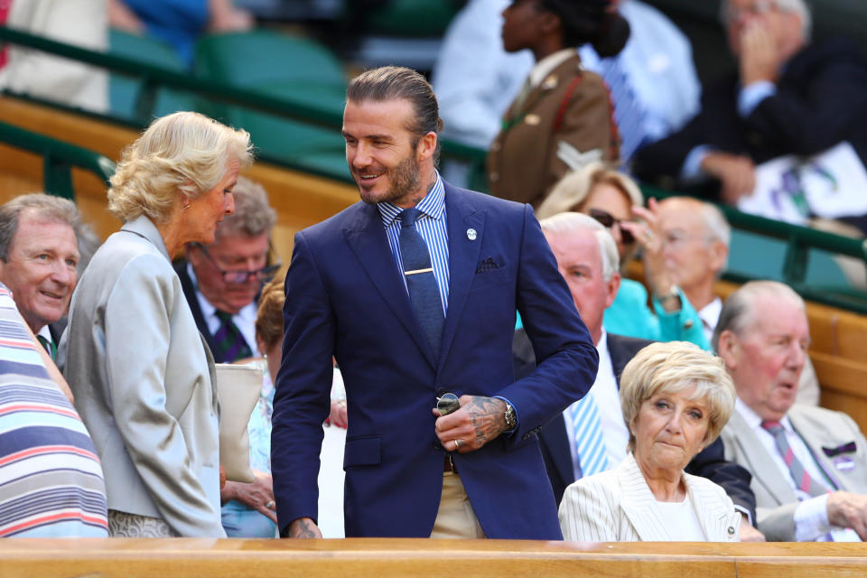 <p>Doing a nice thing and taking his mum to the Royal Box for the day (bottom right, give us a wave Sandra), <a rel="nofollow noopener" href="http://www.esquire.co.uk/style/fashion/news/g9775/20-times-david-beckham-showed-you-the-key-to-modern-mens-style/" target="_blank" data-ylk="slk:David Beckham;elm:context_link;itc:0;sec:content-canvas" class="link ">David Beckham</a> never fails to impress when he's out at the All England Club. As shown by this solid take on 'smart preppy' - Polo Ralph Lauren, of course - with a dash of man bun and hand tat' thrown in. </p>