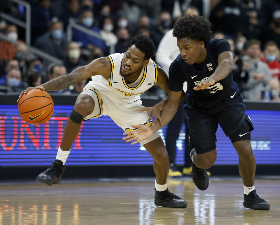 Providence guard Al Durham (1) controls the ball ahead of a steal attempt by Butler guard Chuck Harris (3) during the second half of an NCAA college basketball game, Sunday, Jan. 23, 2022, in Providence, R.I. (AP Photo/Mary Schwalm)