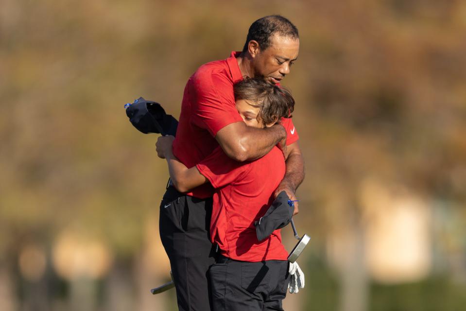 Tiger Woods and son, Charlie, hug after the final round of the PNC Championship golf tournament at Grande Lakes Orlando Course onm Dec. 19, 2021.