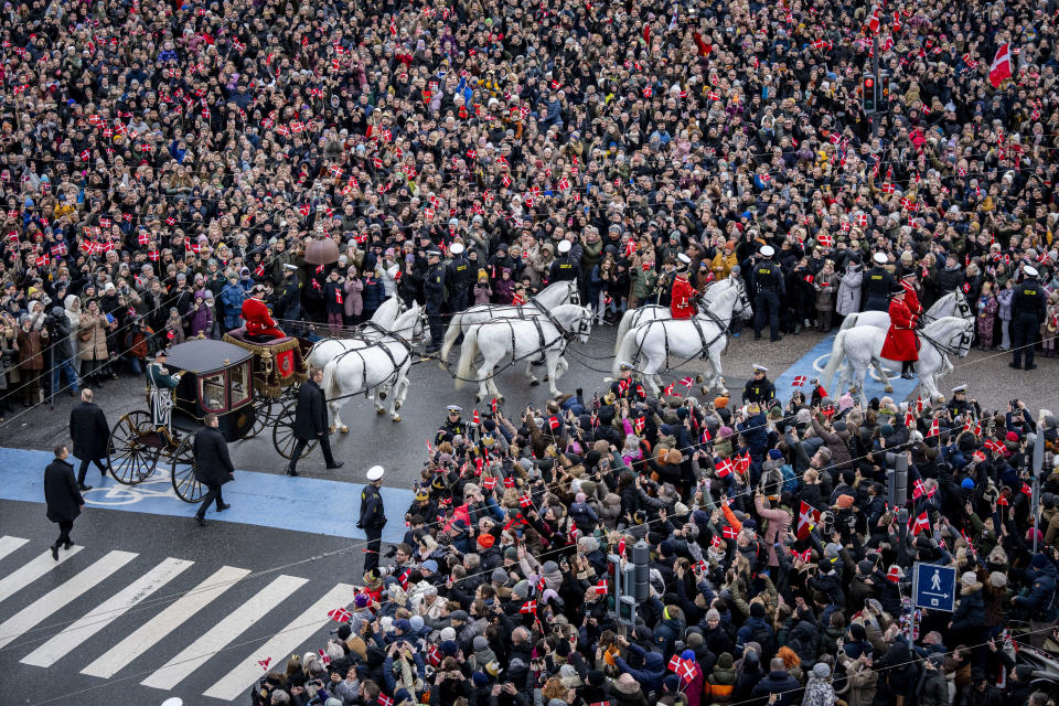 Denmark's Queen Margrethe is escorted by the Guard Hussar Regiment's Mounted Squadron in the gold carriage from Amalienborg Castle to Christiansborg Castle in Copenhagen, Sunday, Jan. 14, 2024. Denmark's Crown Prince Frederik takes over the crown on Sunday from his mother, Queen Margrethe II, who is breaking with centuries of Danish royal tradition and retiring after a 52-year reign. (Ida Marie Odgaard/Ritzau Scanpix via AP)