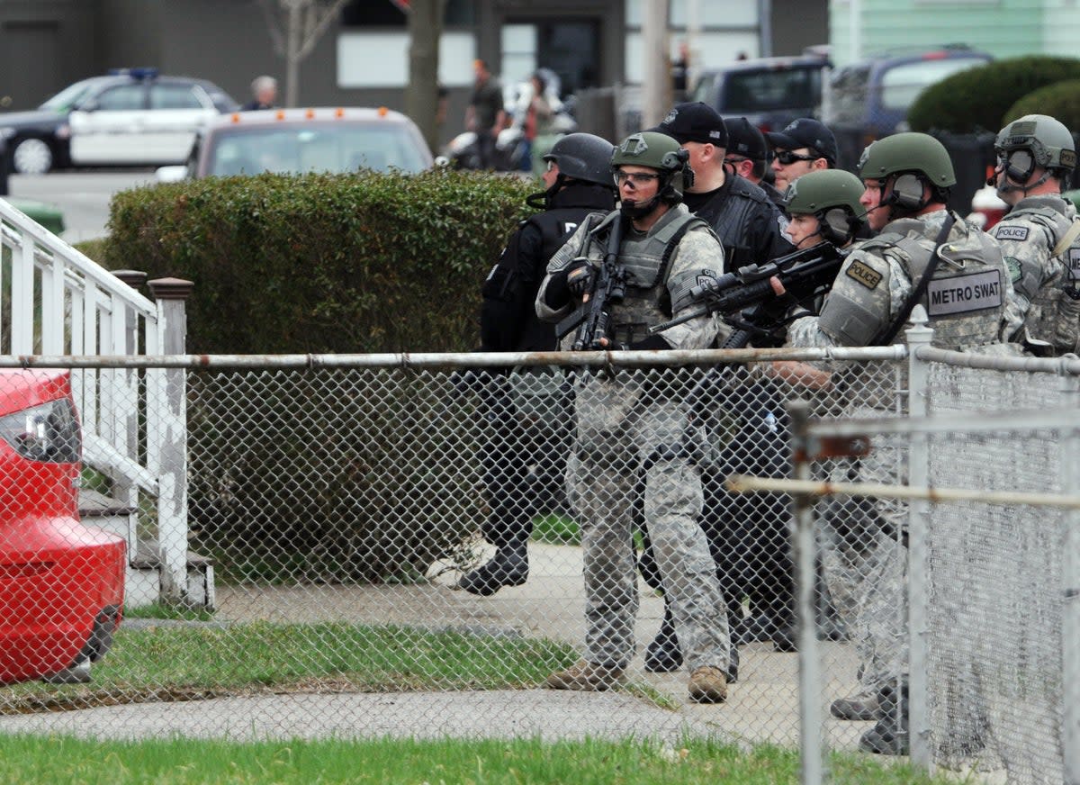 Police conduct a door-to-door search for then-suspect Dzhokhar Tsarnaev on 19 April 2013 in Watertown, Massachusetts (Darren McCollester/Getty Images)