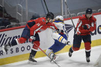 Washington Capitals right wing Richard Panik (14) checks Buffalo Sabres center Eric Staal (12) during the first period of an NHL hockey game, Sunday, Jan. 24, 2021, in Washington. Capitals center Lars Eller (20) looks on. (AP Photo/Nick Wass)