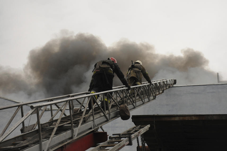 Firefighters work to extinguish a fire after shelling in Kharkiv, Ukraine, Wednesday, April 13, 2022. (AP Photo/Andrew Marienko)