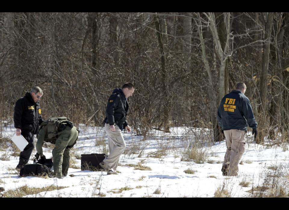 FBI and local police investigators search for evidence in a rural area of Chardon Township, Ohio Monday, Feb. 27, 2012. A gunman opened fire inside the Chardon High School cafeteria at the start of the school day Monday, killing three students and wounding two others, officials said. (AP Photo/Mark Duncan)