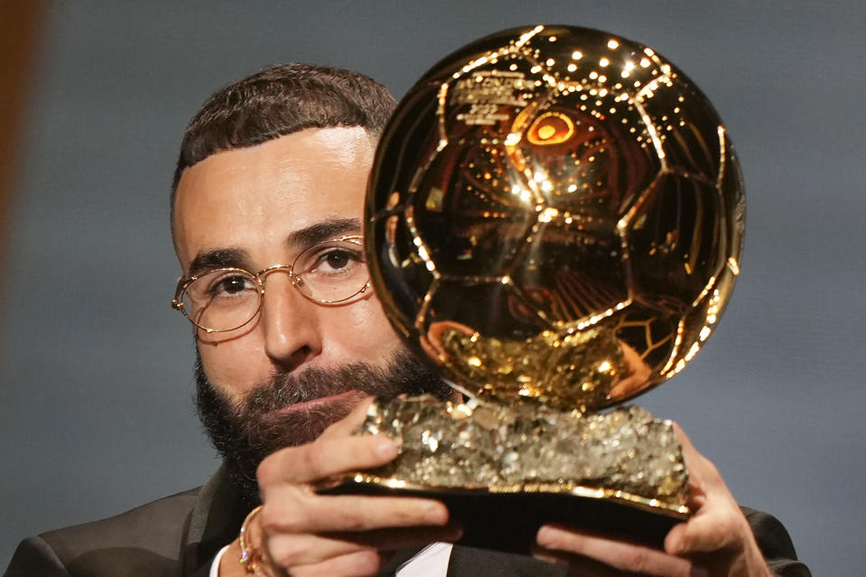 FILE - Real Madrid's Karim Benzema celebrates after winning the 2022 Ballon d'Or trophy during the 66th Ballon d'Or ceremony at Theatre du Chatelet in Paris, France, Monday, Oct. 17, 2022. (AP Photo/Francois Mori, File)