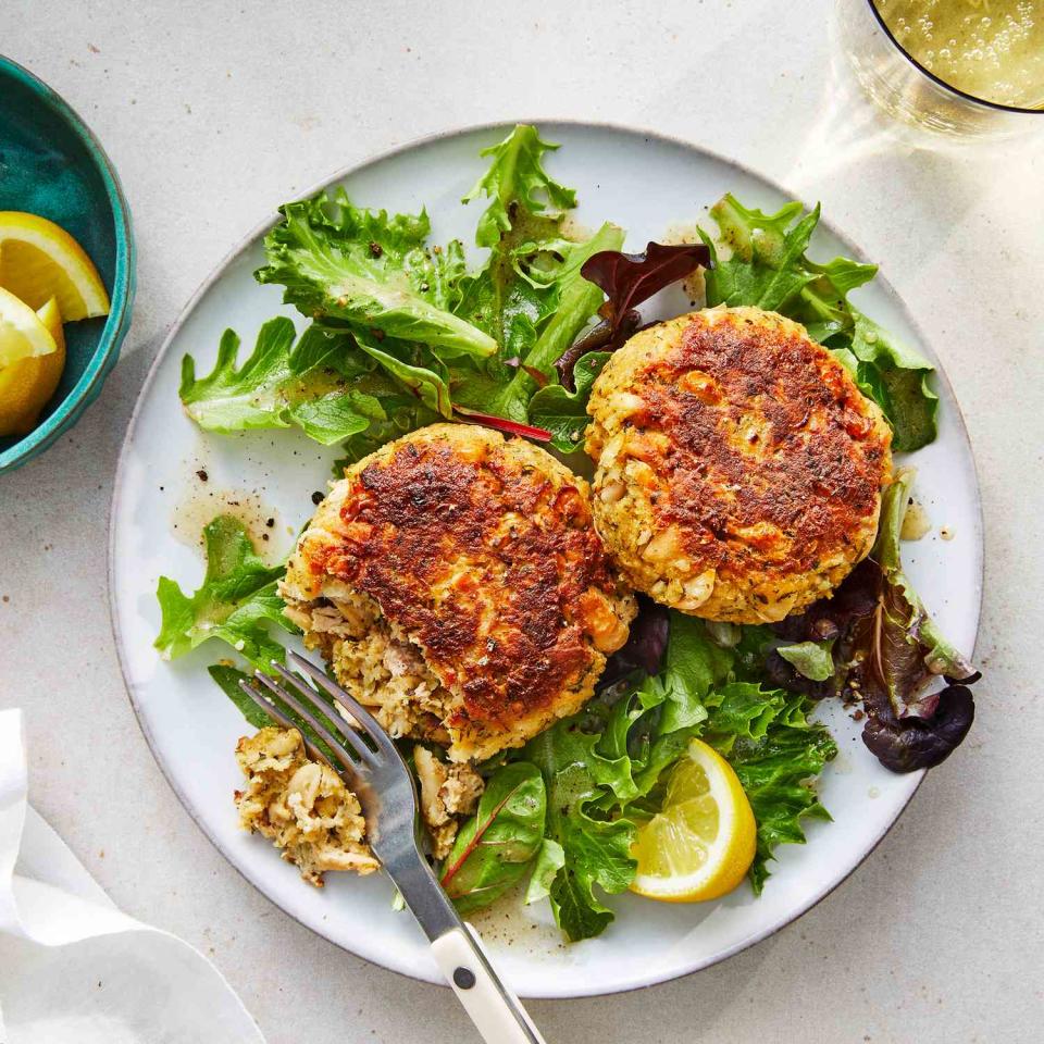 <p>Dried herbs, white beans and canned tuna come together in these easy tuna cakes served over greens. A lemony dressing ties this quick dinner together.</p> <p> <a href="https://www.eatingwell.com/recipe/7906373/tuna-cakes/" rel="nofollow noopener" target="_blank" data-ylk="slk:View Recipe" class="link ">View Recipe</a></p>