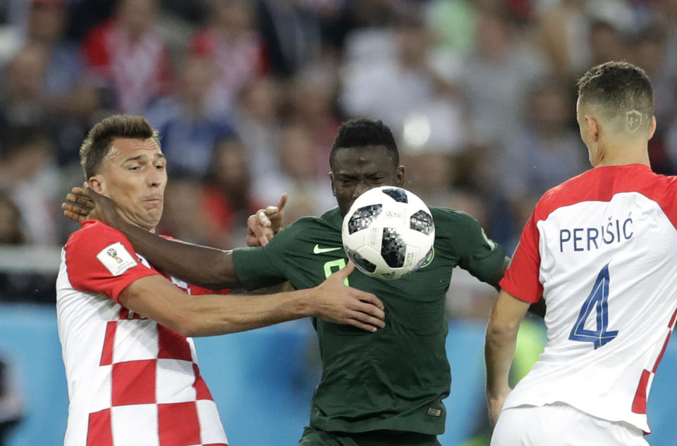 <p>No inch given: Mario Mandzukic and Oghenekaro Etebo fight for possession in Kalingrad. (AP) </p>