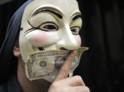 A demonstrator poses with a dollar bill during the march to JP Morgan at One Chase Manhattan Plaza, New York.