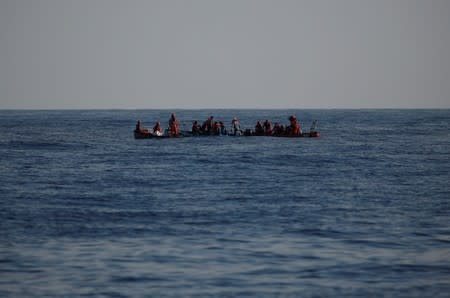 RHIBs of the German NGO Sea-Eye migrant rescue ship 'Alan Kurdi' rescue migrants claiming to be Tunisians from a small wooden boat in the central Mediterranean Sea