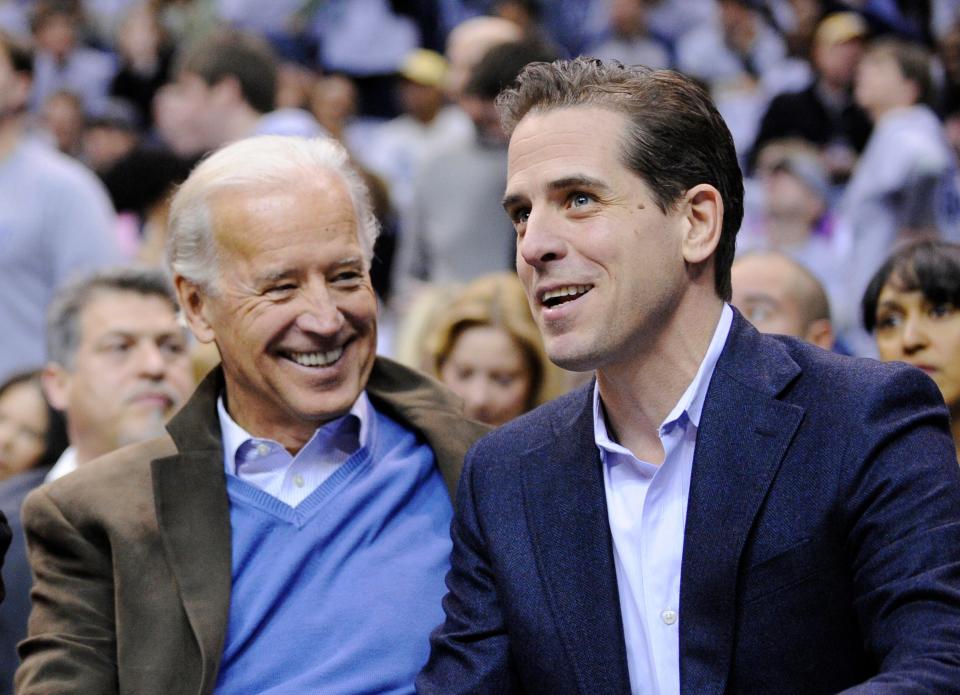 Then Vice President Joe Biden, left, and his son Hunter Biden appear at the Duke Georgetown NCAA college basketball game in Washington on Jan. 30, 2010. That same month, Hunter was introduced via email to Bloom Energy.